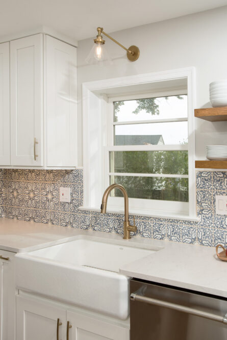 gold-faucet-white-kitchen-sink-tile-backsplash