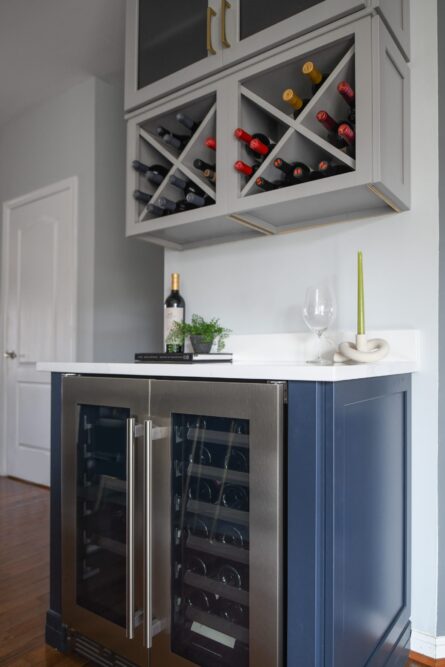 Photo of a kitchen design project in Ashburn VA featuring a soothing gray and blue color palette and a customized wine storage solution