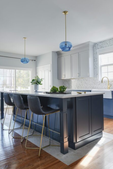 Photo of a kitchen design project in Ashburn VA featuring a soothing gray and blue color palette and a custom island with comfortable seating for six