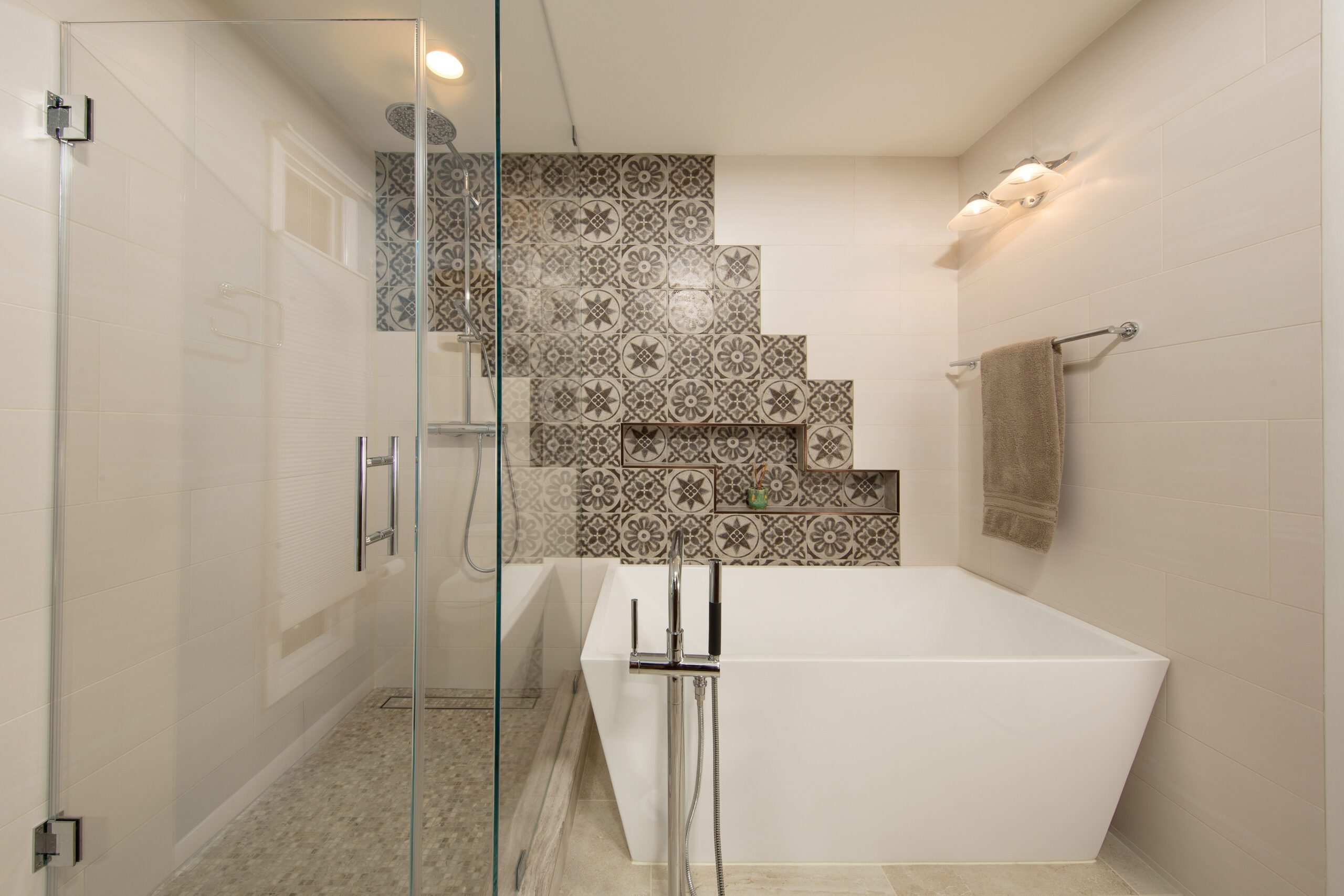 A photo of custom tile work and an oversized free-standing tub in a European style bathroom